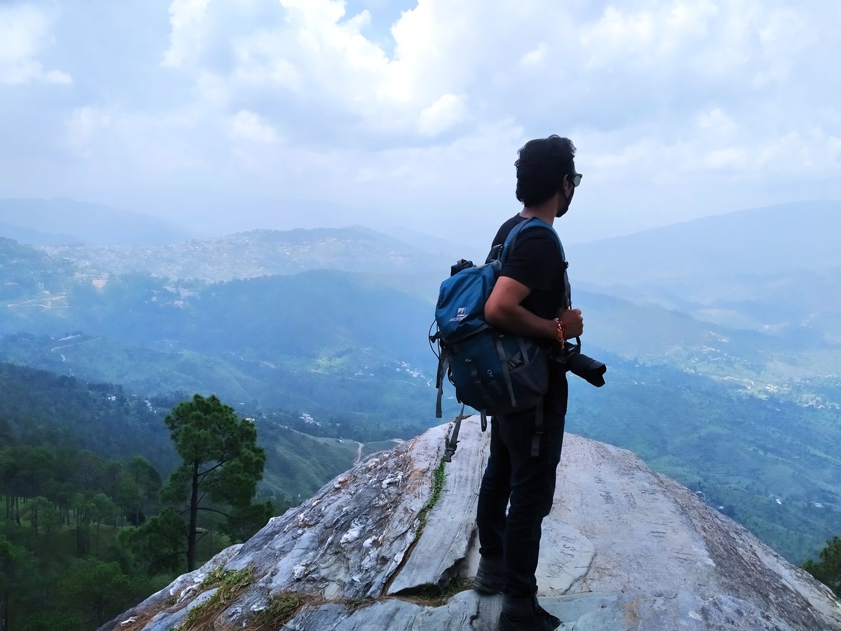 Travel journal photographer looking at a mountain vista