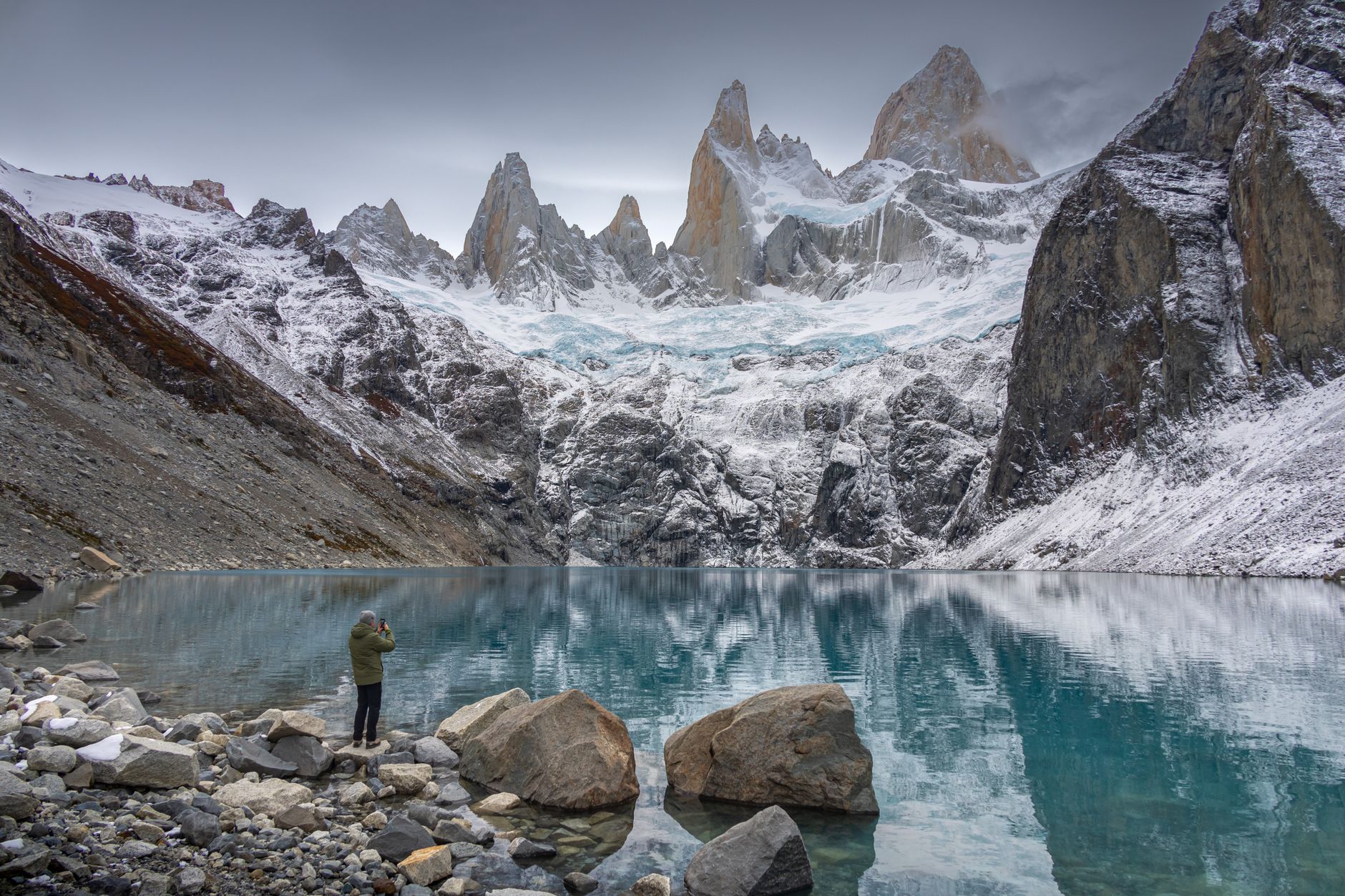 Lone hiker walking along ridge overlooking Patagonian ice field