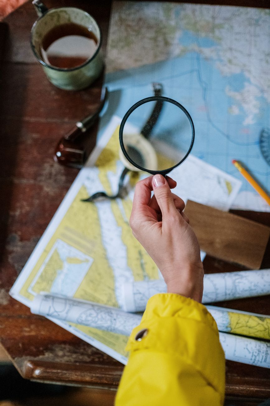 Vintage map and compass on rustic oak table